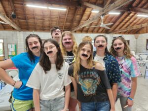 mustachioed high school campers